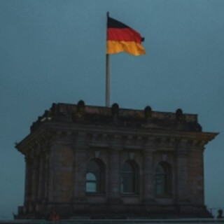 German flag above the Reichstag at dusk