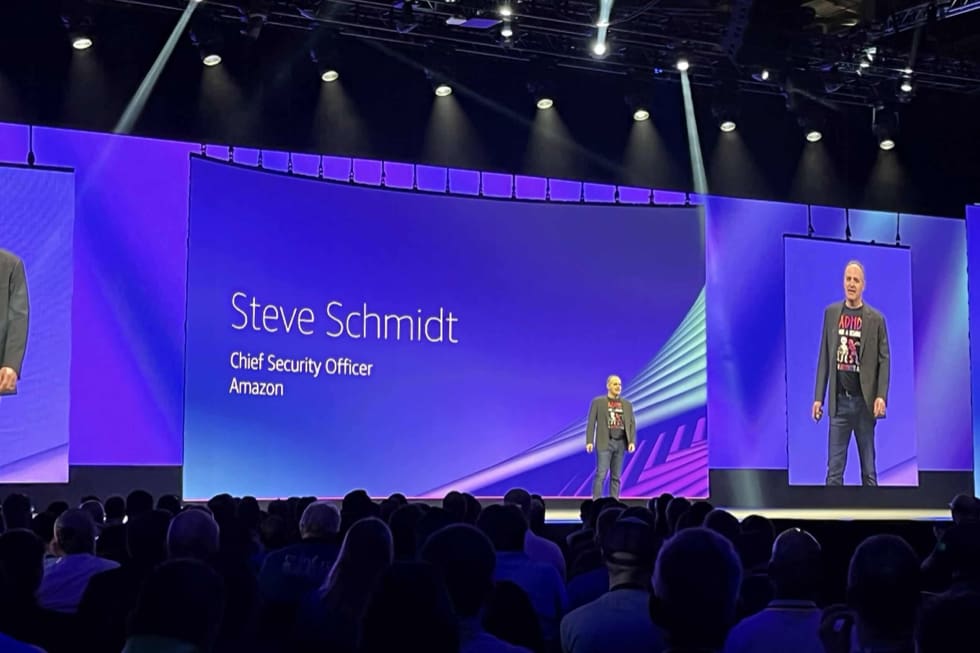 An AWS Security keynote stage with Steve Schmidt on screen and a seated audience.